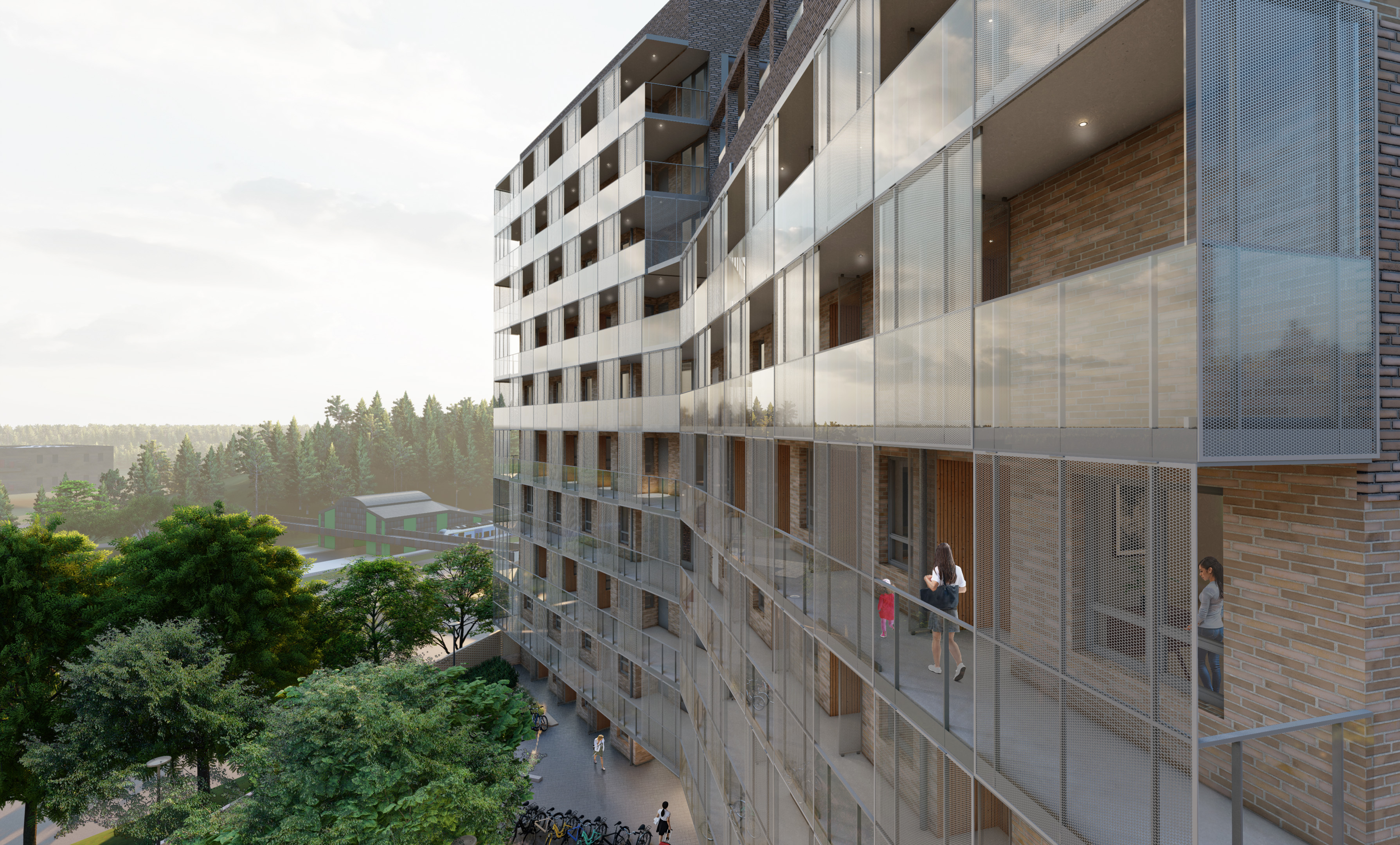 Flervåningshus med loftgångar uppe på en höjd med utsikt över gröna träd, hus och pendeltåg.