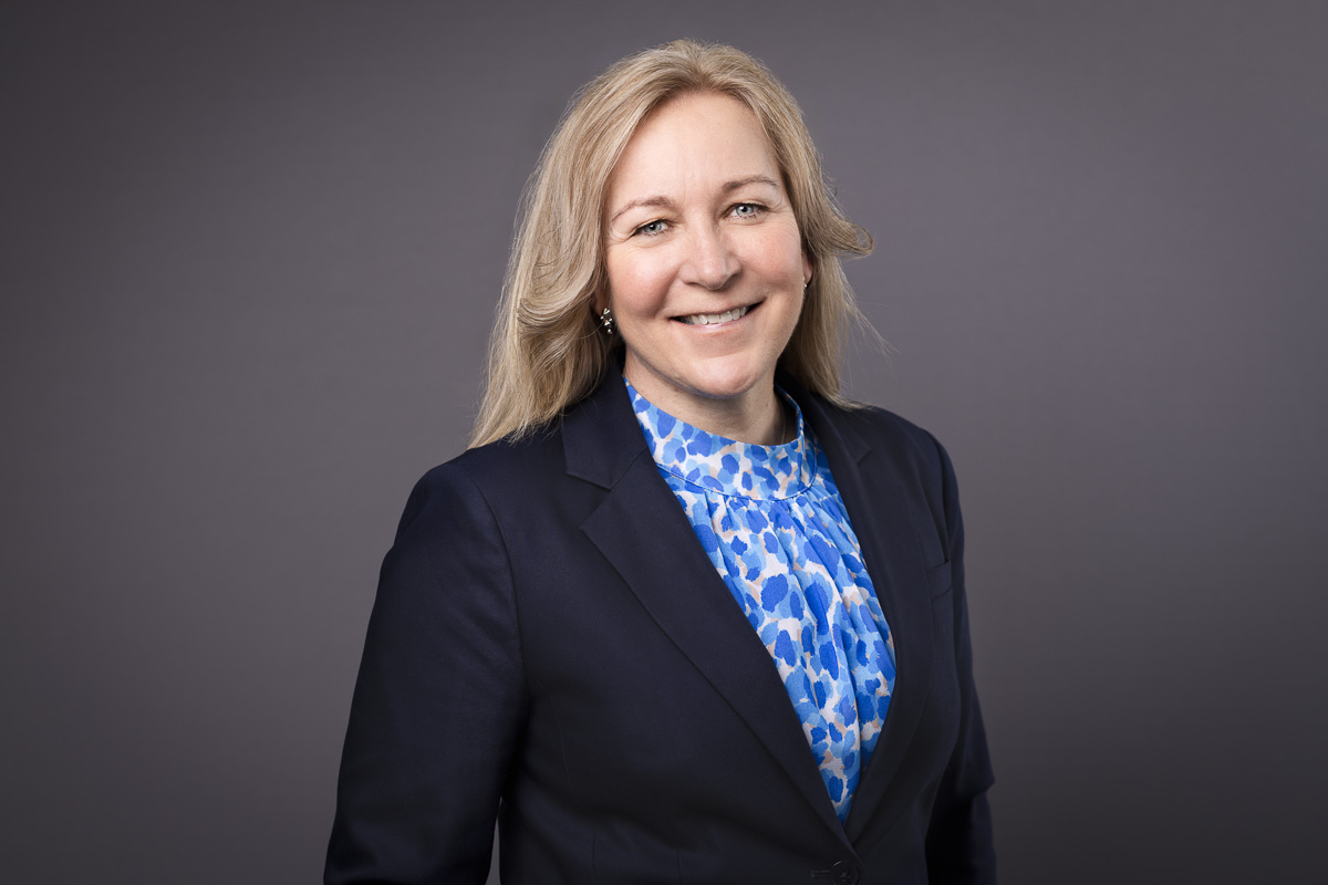 Anna Mellström i blus och kavaj med mörk bakgrund.