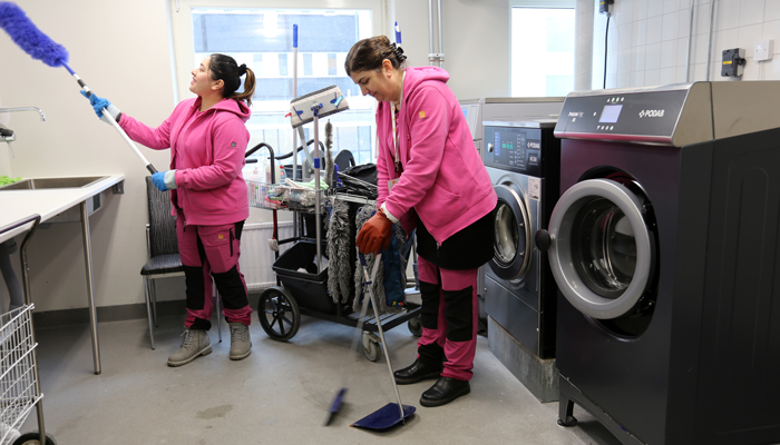 Personal från Qvinna i Botkyrka städar en tvättstuga i Fittja
